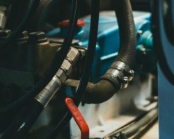 Detailed view of an industrial engine showcasing hoses, levers, and painted parts.